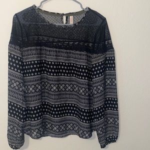 Black long sleeve blouse with white patterns.